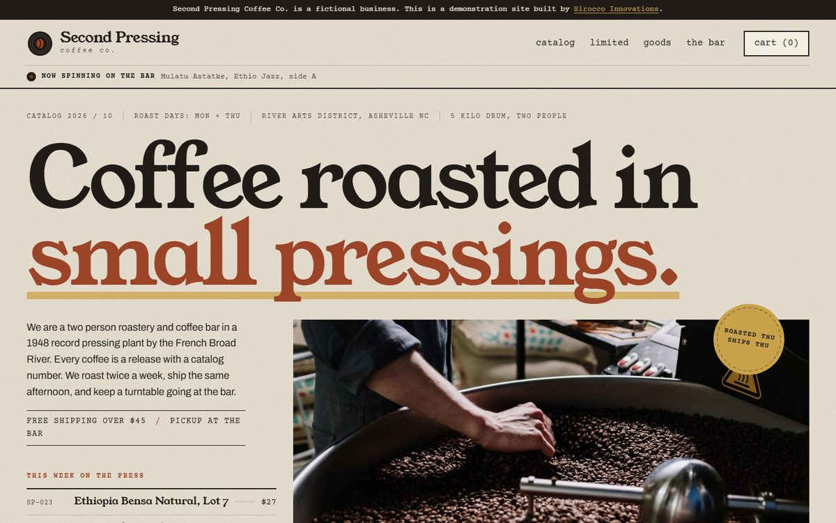 The Second Pressing Coffee Co. home page, the headline Coffee roasted in small pressings above a photo of a hand turning beans in the roaster