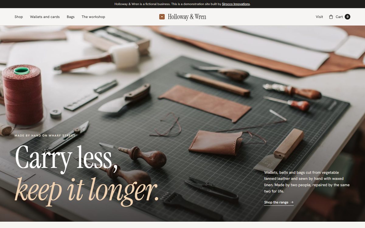 The Holloway and Wren home page, leatherworking tools and cut leather on a cutting mat beside the headline Carry less, keep it longer