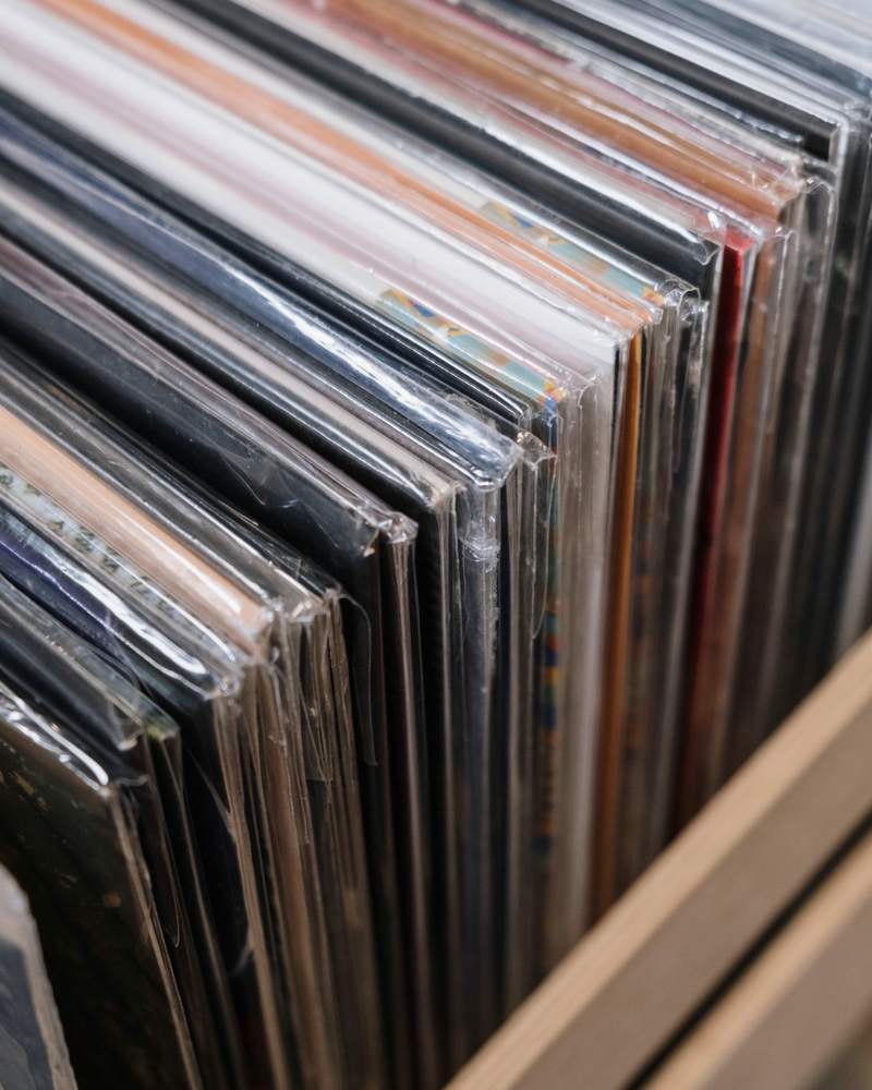 A wooden crate packed with LPs in clear plastic sleeves