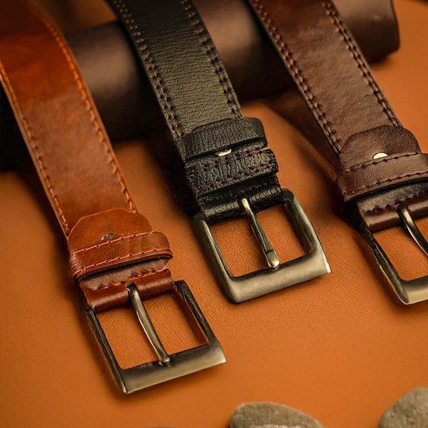 Three leather belts in tan, black and dark brown with square buckles