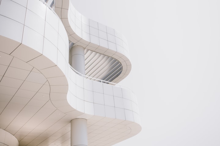 A pale sculpted ceiling curving into a rounded opening, lit evenly by daylight from beyond the frame.